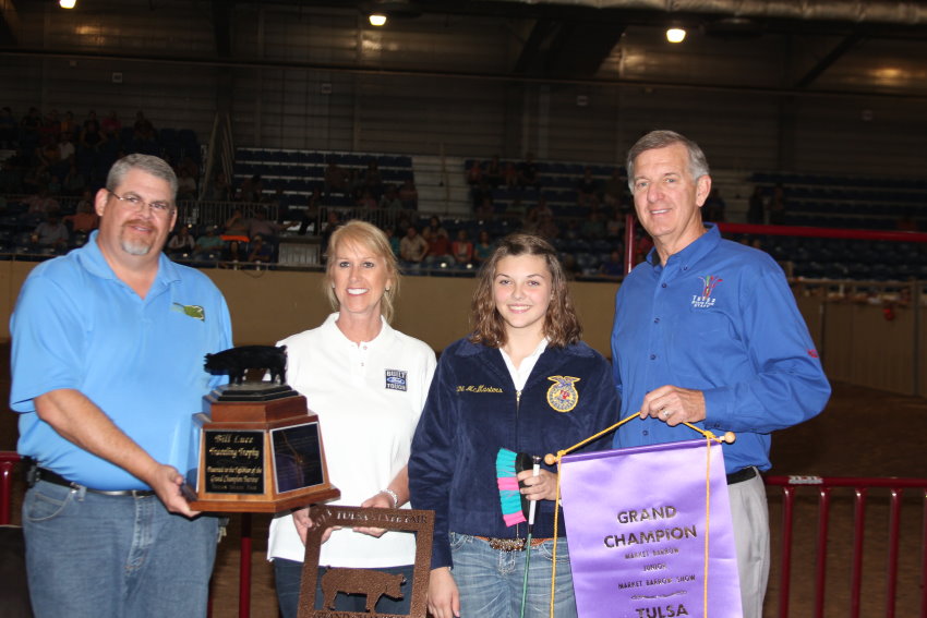 Jayme McMasters of the Depew FFA Shows Grand Champion Barrow at Tulsa State Fair