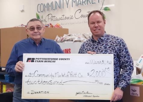 Pottawatomie County Farm Bureau president John Grundmann presented a $2,000 from OKFB Community Food Assistance Matching Program